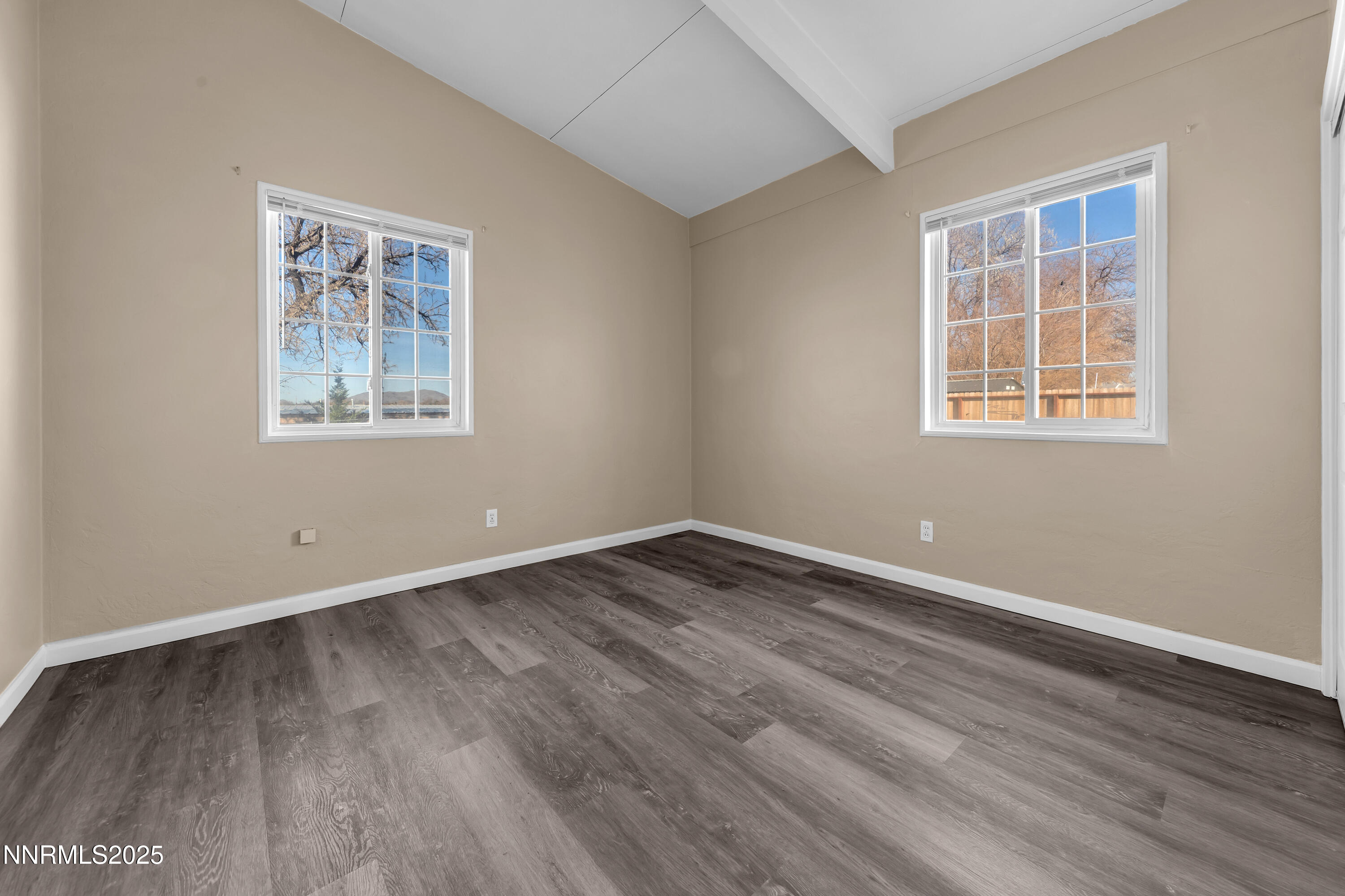 12360 Rocky Mountain Street Reno, NV 89506 - Photo 17 of 29 a view of an empty room with wooden floor and a window