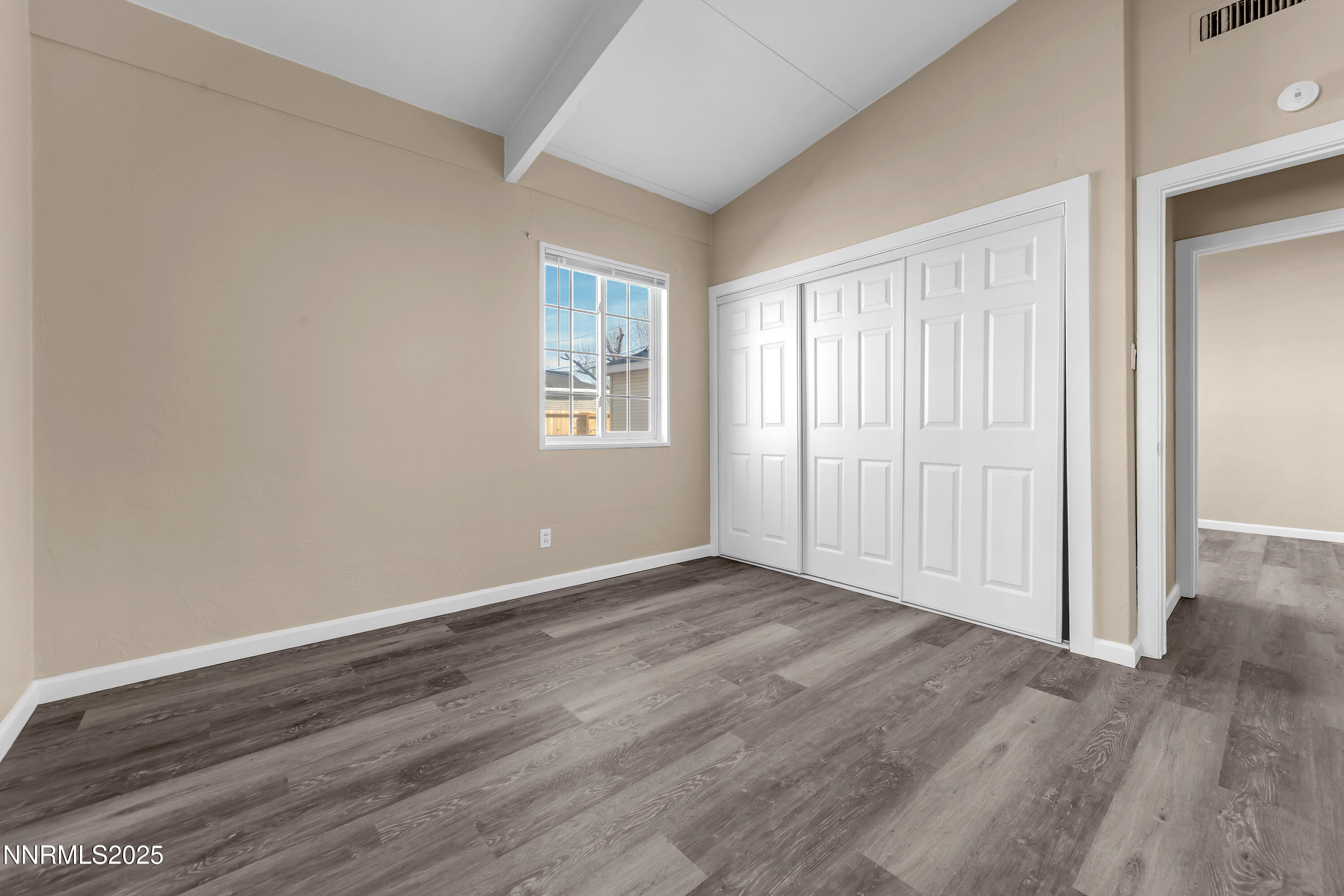 12360 Rocky Mountain Street Reno, NV 89506 - Photo 18 of 29 an empty room with wooden floor and windows