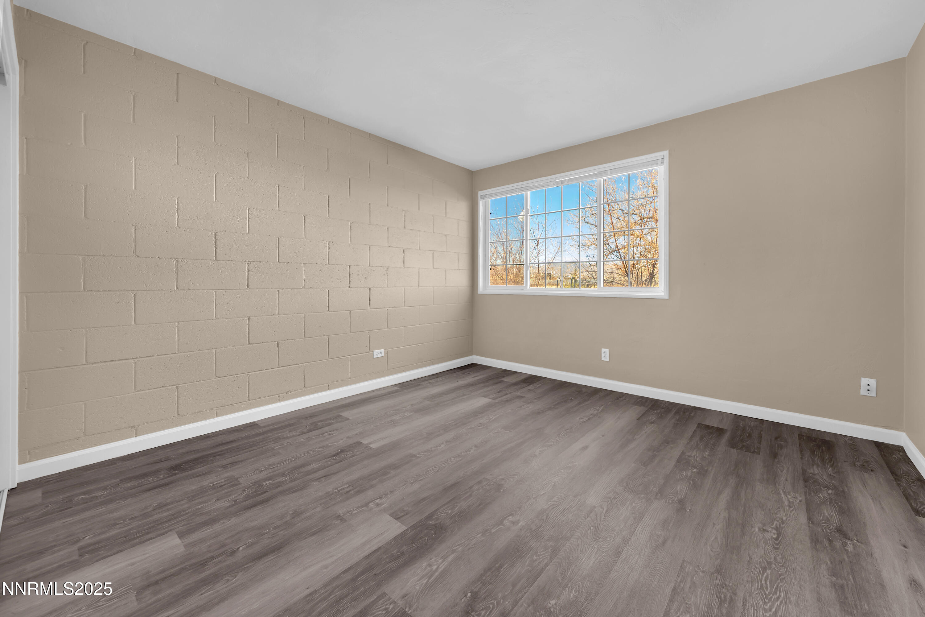12360 Rocky Mountain Street Reno, NV 89506 - Photo 19 of 29 an empty room with wooden floor and windows