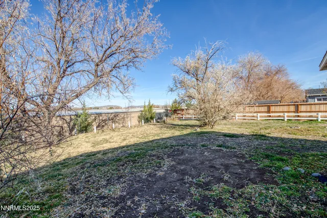 a white house that has a tree in front of it