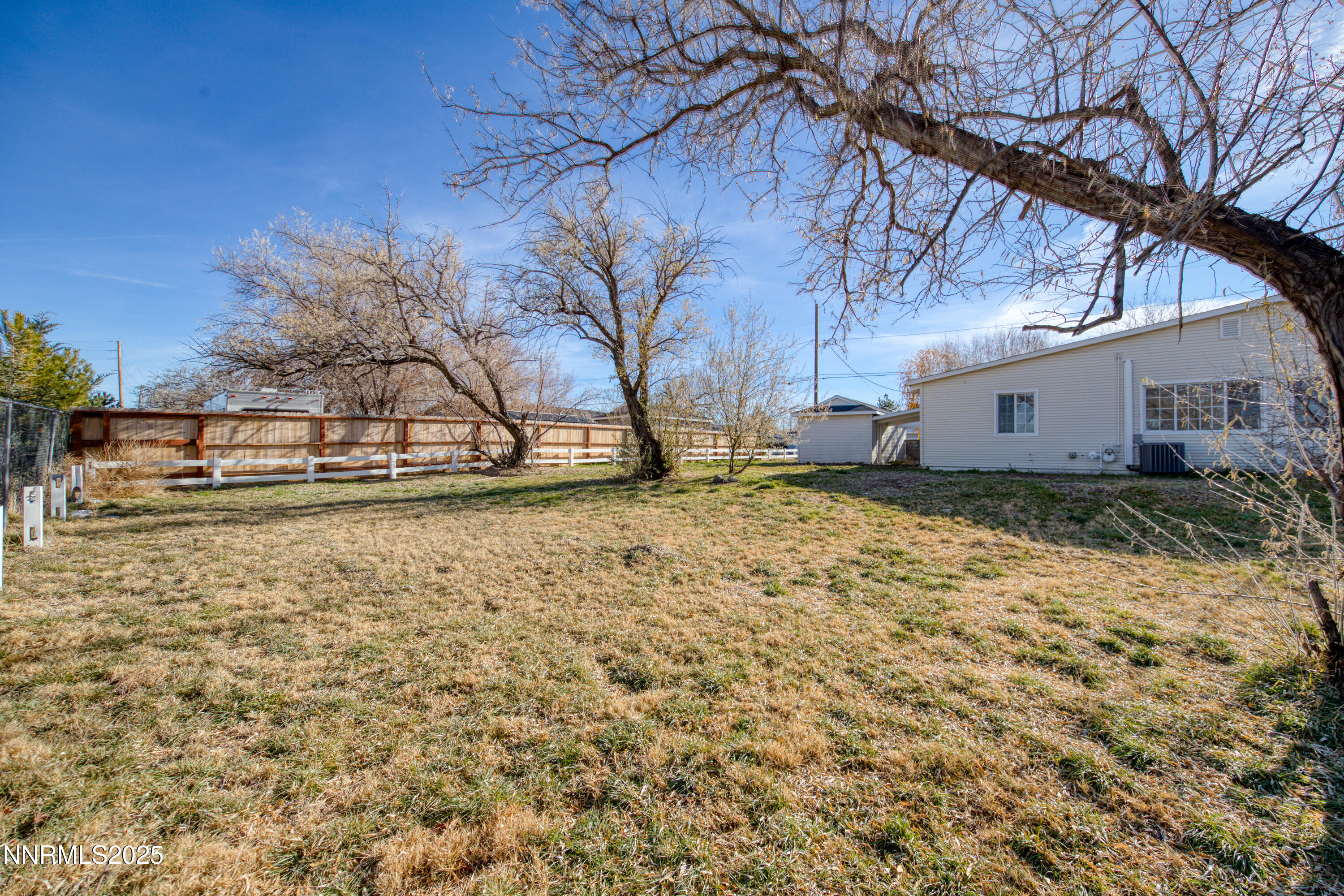 12360 Rocky Mountain Street Reno, NV 89506 - Photo 23 of 29 a white house that has a tree in front of it