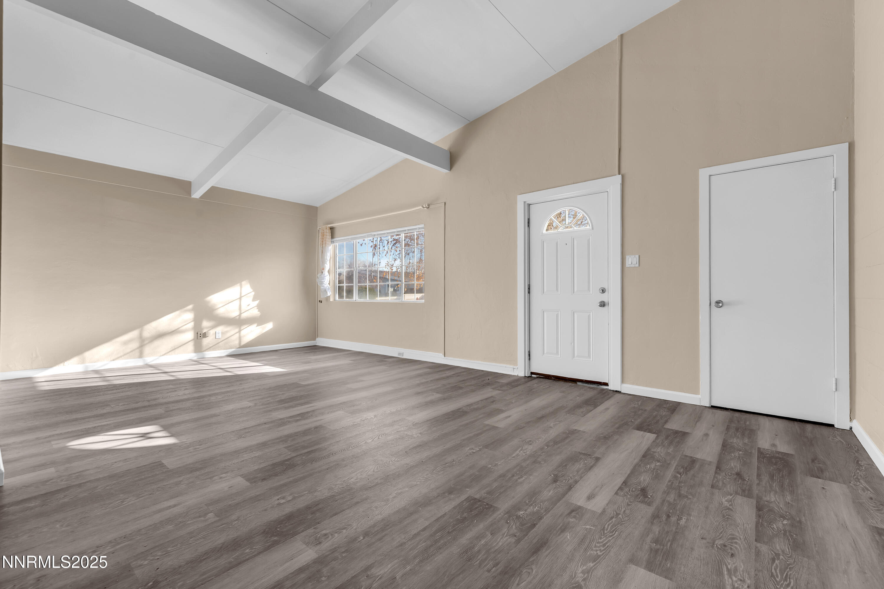 12360 Rocky Mountain Street Reno, NV 89506 - Photo 7 of 29 a view of empty room with wooden floor and fan