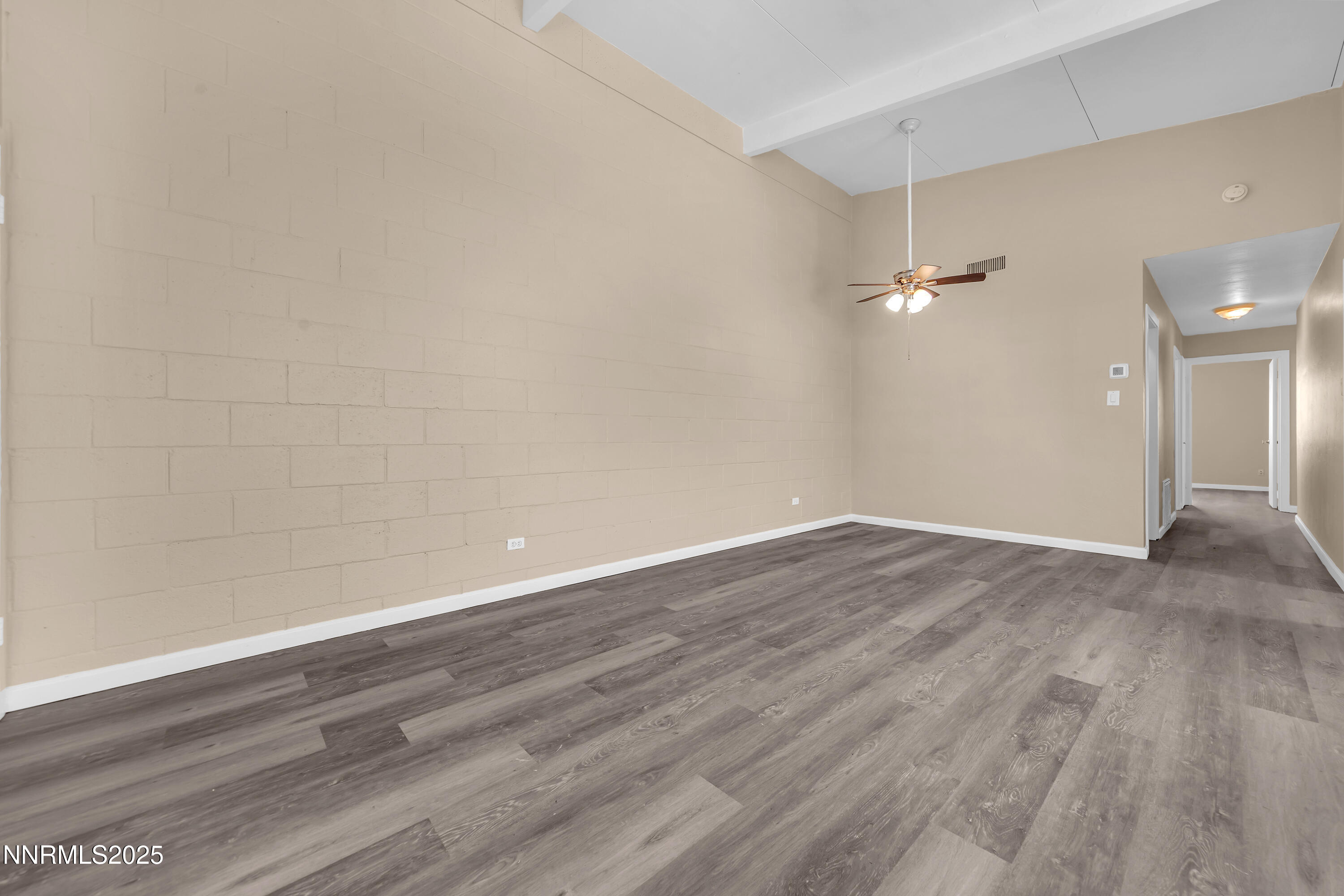 12360 Rocky Mountain Street Reno, NV 89506 - Photo 9 of 29 a view of an empty room with wooden floor