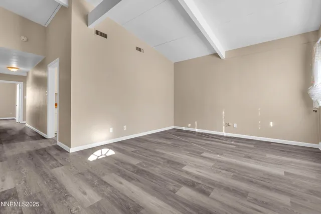 a view of an empty room and wooden floor