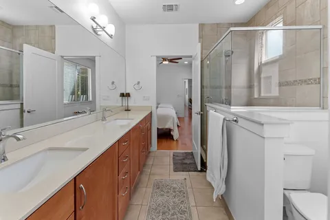 a bathroom with a double vanity sink and mirror