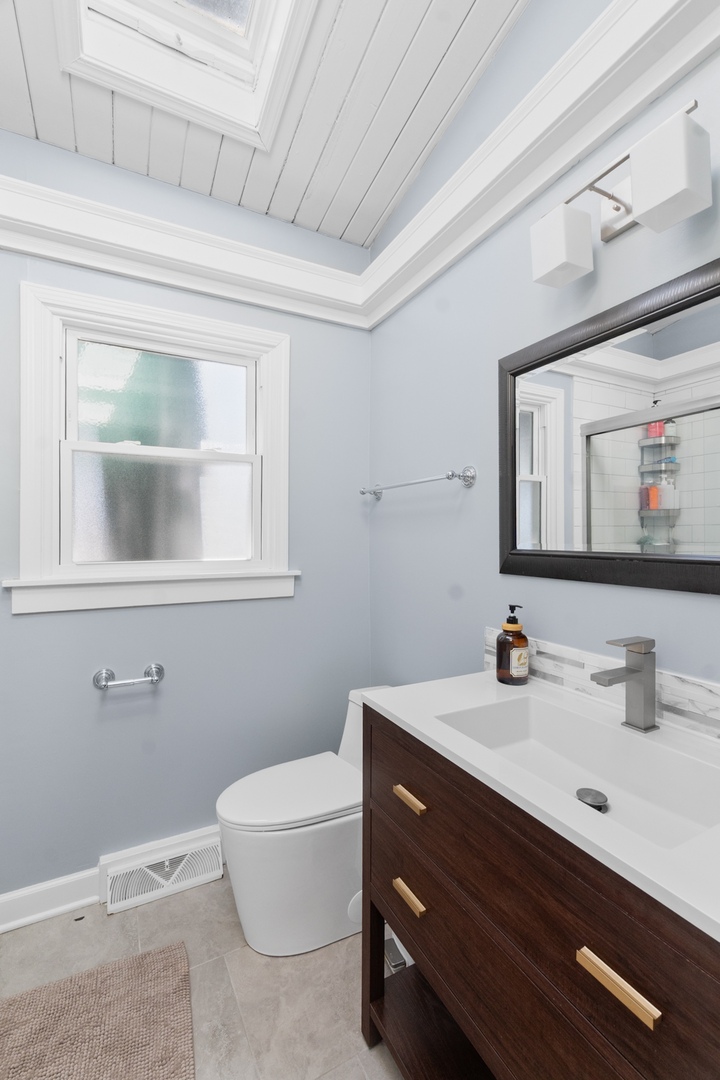 8 Rob Road Mount Prospect, IL 60056 - Photo 21 of 40 a bathroom with a sink and a mirror