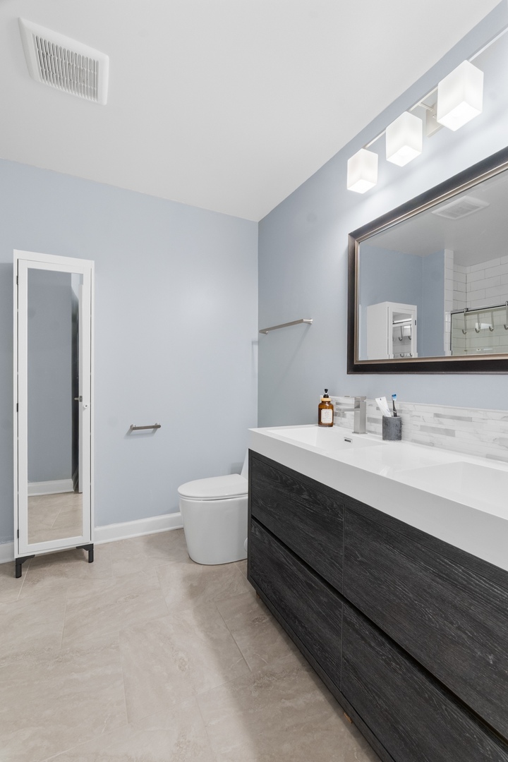 8 Rob Road Mount Prospect, IL 60056 - Photo 28 of 40 a bathroom with a sink and a mirror