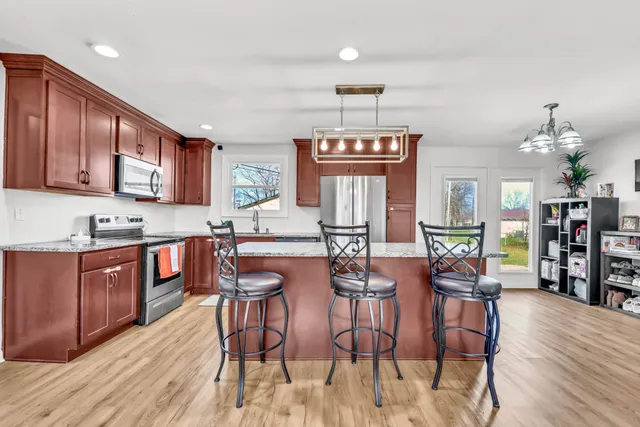 a large kitchen with a table and chairs
