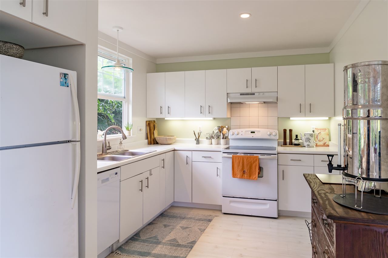 266 Waiama Way Haiku, HI 96708 - Photo 23 of 30 a kitchen with a refrigerator and a stove top oven