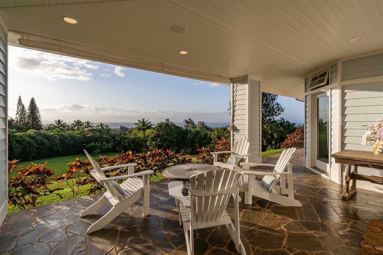 266 Waiama Way Haiku, HI 96708 - Photo 5 of 30 a view of a patio with a dining table and chairs with wooden floor