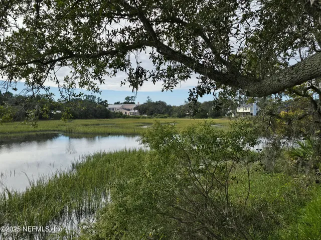 a view of a lake with houses in background