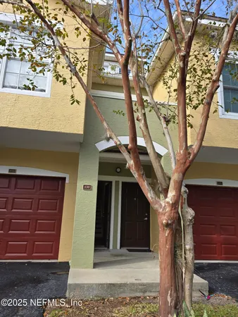a view of a house with a tree