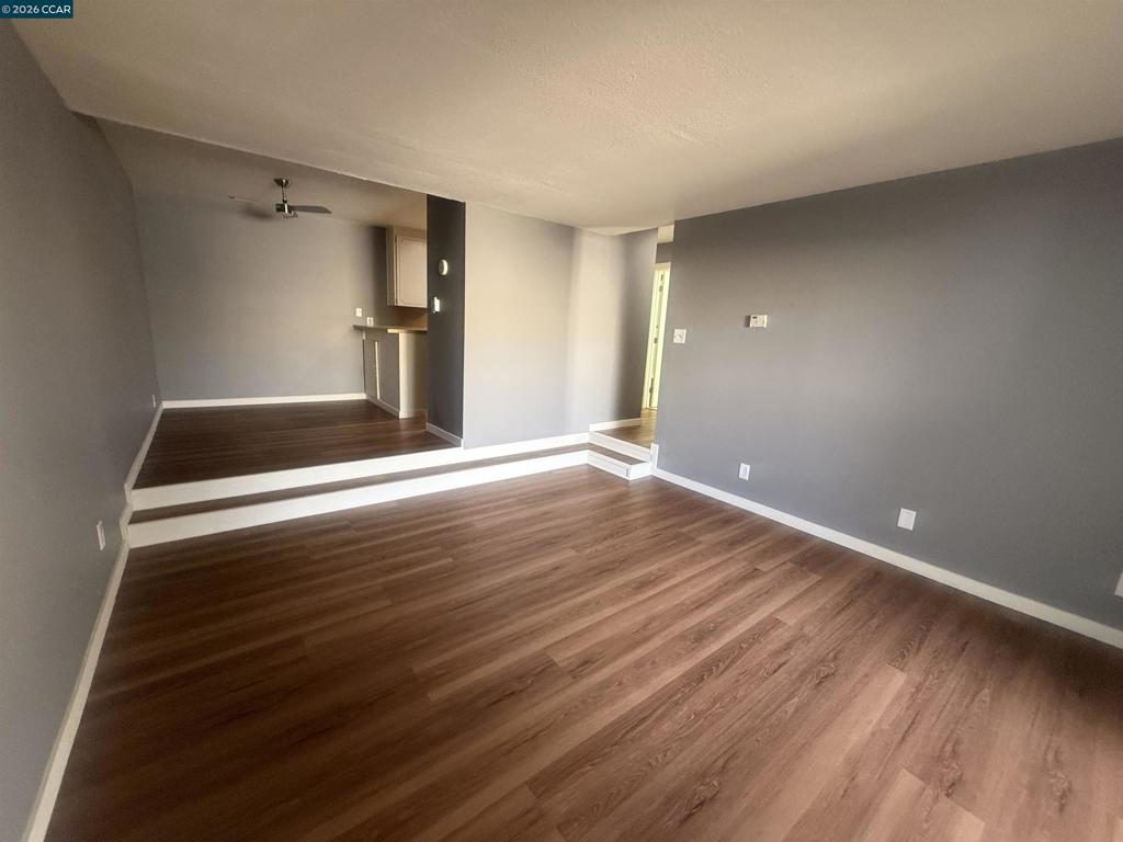 1591 Ellis Street Concord, CA 94520 - Photo 8 of 11 a view of an empty room with wooden floor and a window