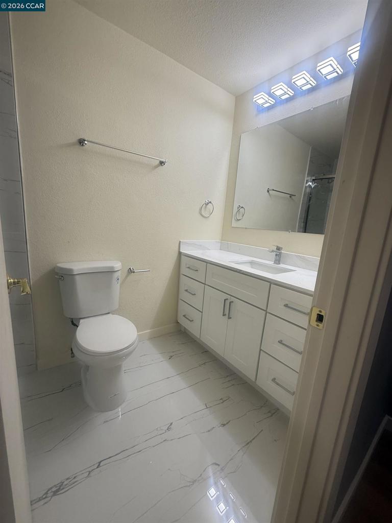 1591 Ellis Street Concord, CA 94520 - Photo 10 of 11 a bathroom with a toilet sink and mirror