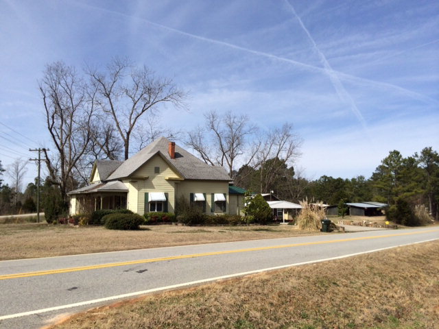 8677 Hopewell Road Lizella, GA 31052 - Photo 14 of 20 a front view of a house with a yard and a garage