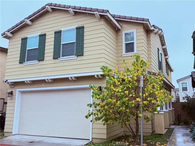 a front view of a house with plants