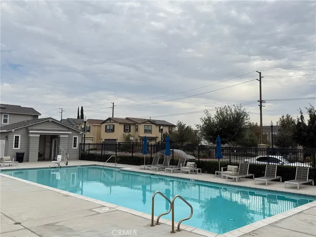 a view of yard with house and car parked in the background