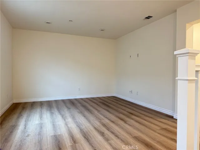 a view of a room with wooden floor