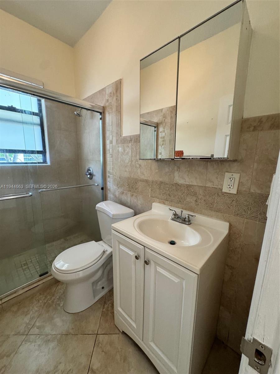 2000 Monroe Street, Unit 11 Hollywood, FL 33020 - Photo 16 of 22 a bathroom with a toilet sink and mirror