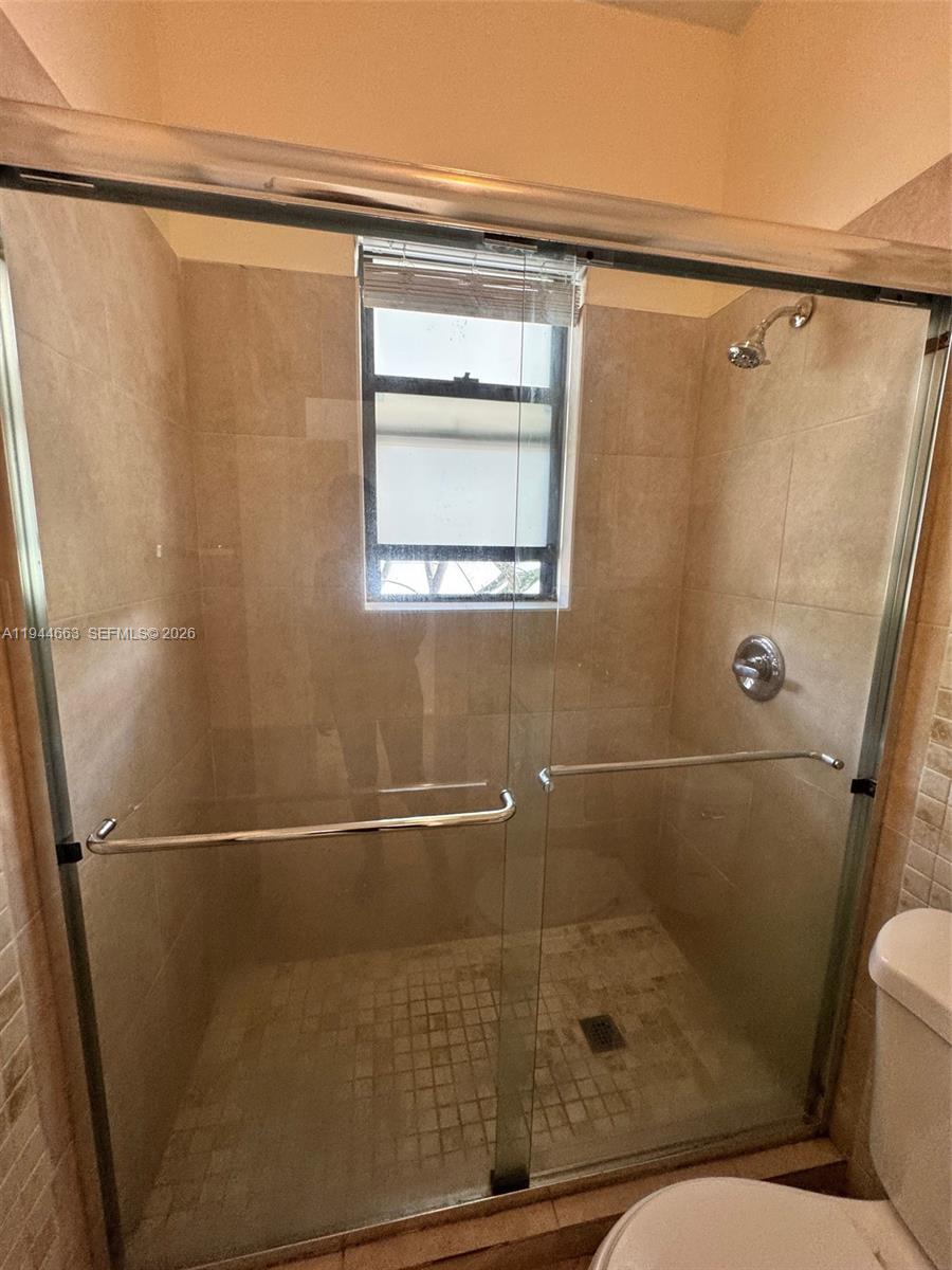 2000 Monroe Street, Unit 11 Hollywood, FL 33020 - Photo 18 of 22 a bathroom with a shower and toilet