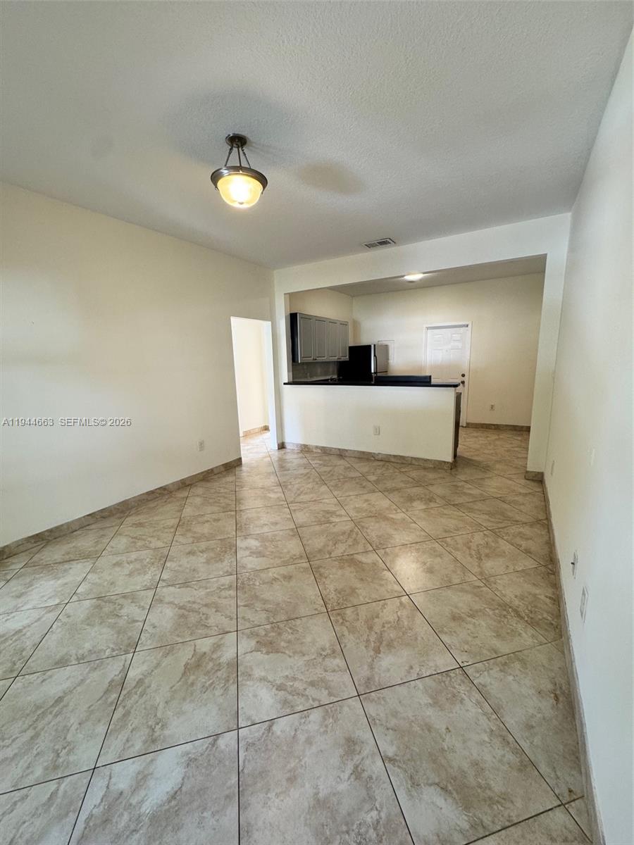 2000 Monroe Street, Unit 11 Hollywood, FL 33020 - Photo 4 of 22 a view of a kitchen with a sink and a refrigerator
