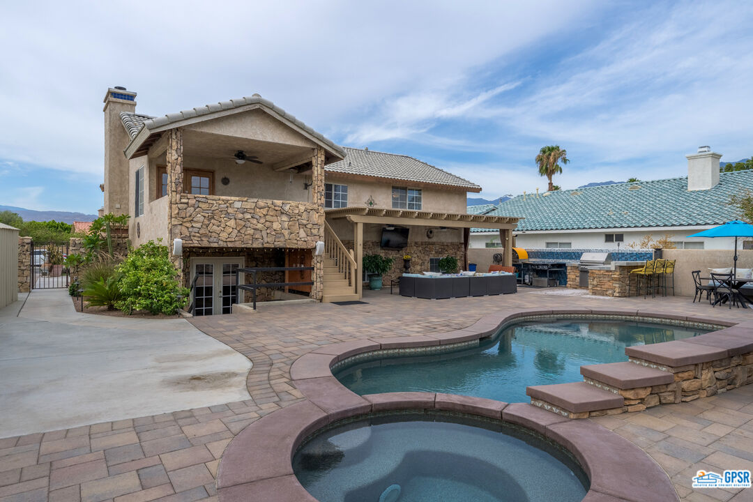 68554 Durango Road Cathedral City, CA 92234 - Photo 13 of 47 a front view of a house with swimming pool