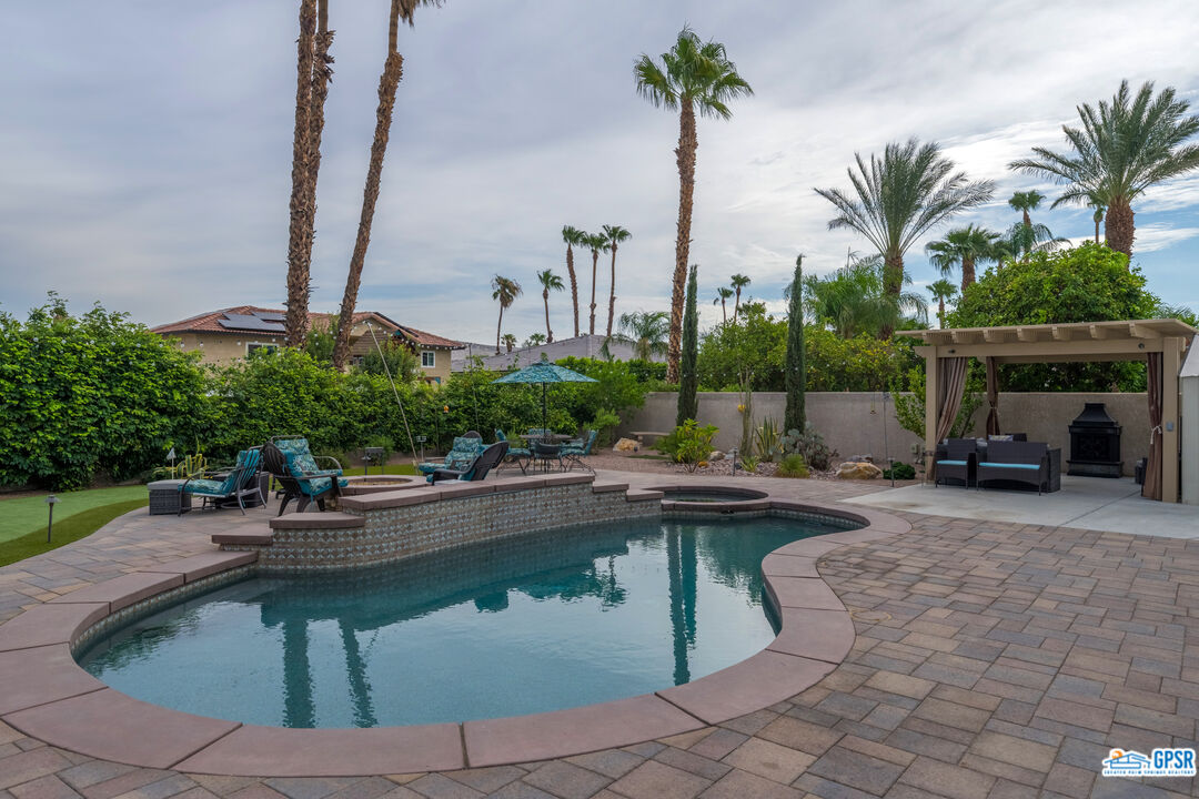 68554 Durango Road Cathedral City, CA 92234 - Photo 15 of 47 a view of a swimming pool with a table and chairs
