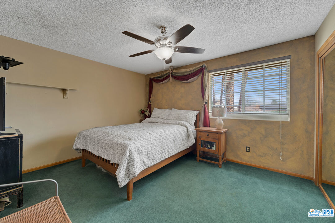 68554 Durango Road Cathedral City, CA 92234 - Photo 21 of 47 a bedroom with a bed and window