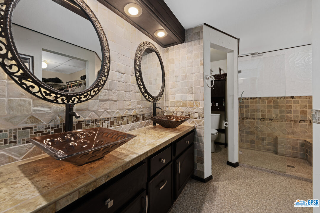 68554 Durango Road Cathedral City, CA 92234 - Photo 26 of 47 a bathroom with a granite countertop sink and a mirror