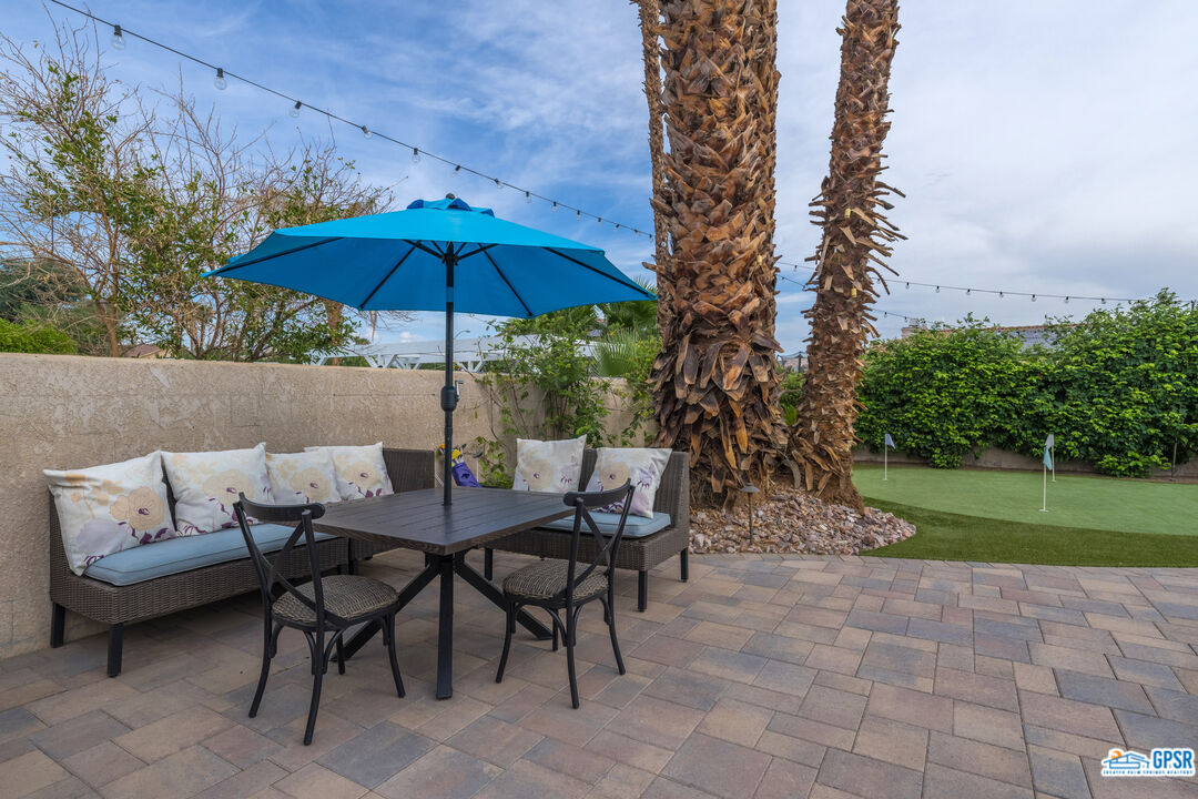 68554 Durango Road Cathedral City, CA 92234 - Photo 39 of 47 a view of patio with chairs and table under an umbrella