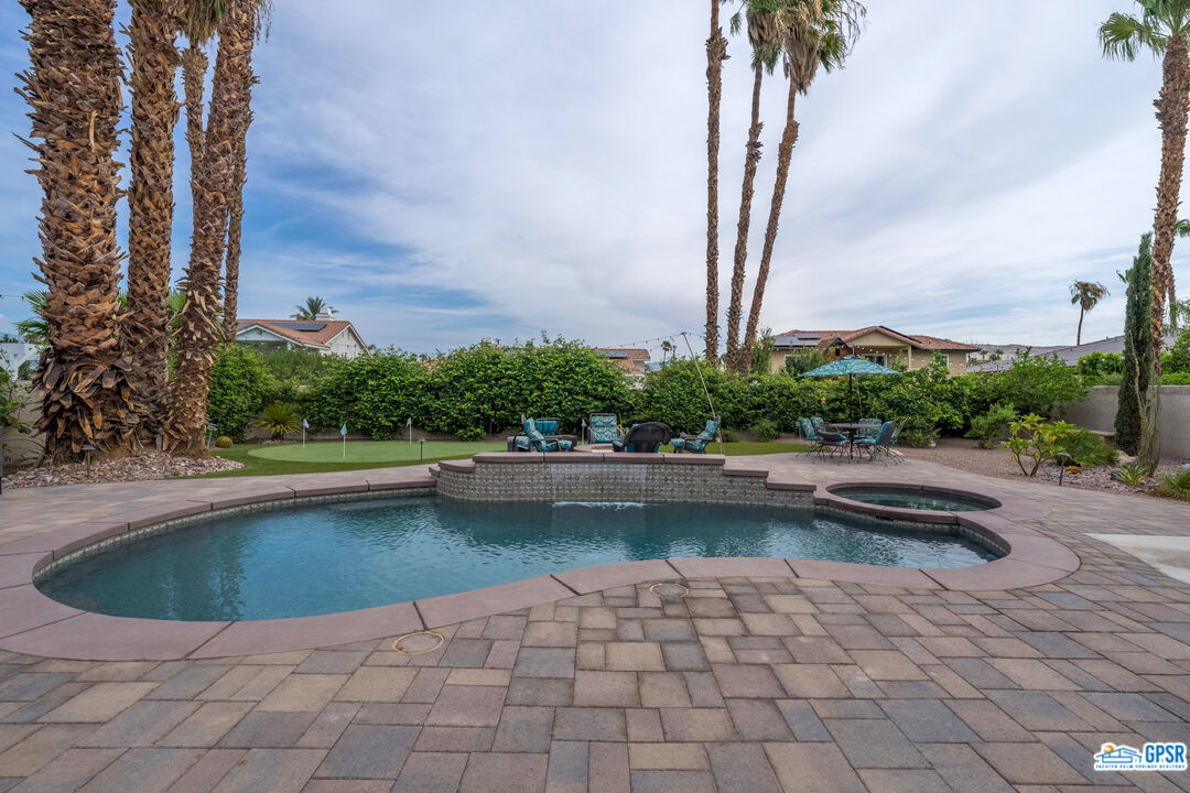 68554 Durango Road Cathedral City, CA 92234 - Photo 42 of 47 a view of a swimming pool with a yard and lake view in back
