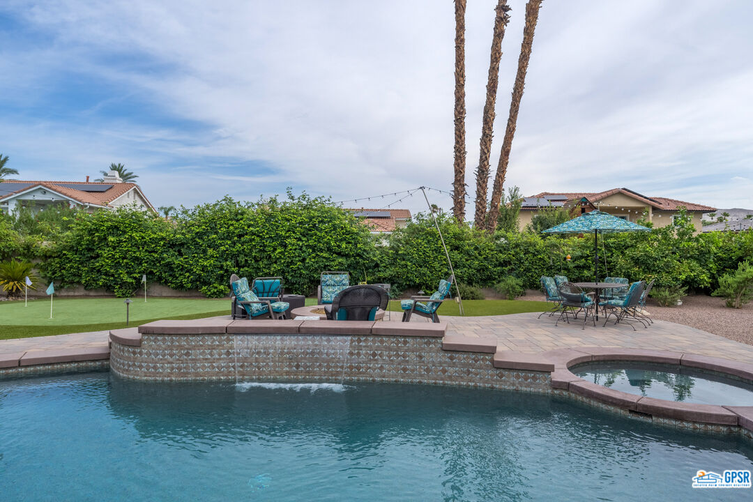 68554 Durango Road Cathedral City, CA 92234 - Photo 43 of 47 a view of a swimming pool with a patio and a garden