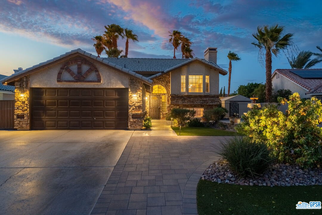 68554 Durango Road Cathedral City, CA 92234 - Photo 9 of 47 a front view of a house with a yard and garage