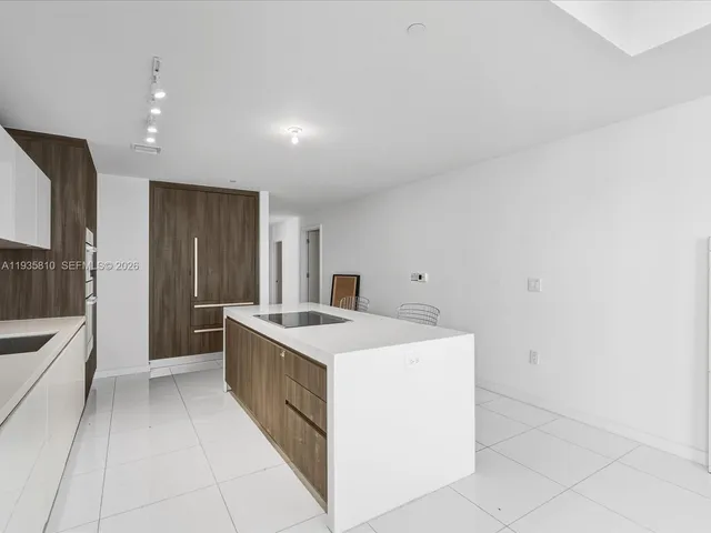 a kitchen with stainless steel appliances a refrigerator and a sink