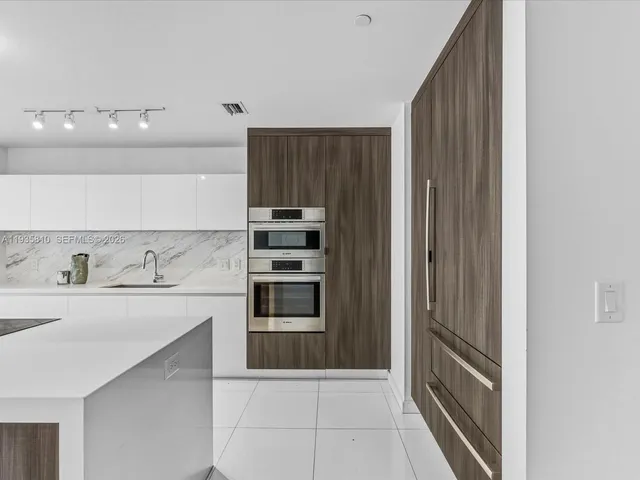 a kitchen with a sink and a refrigerator