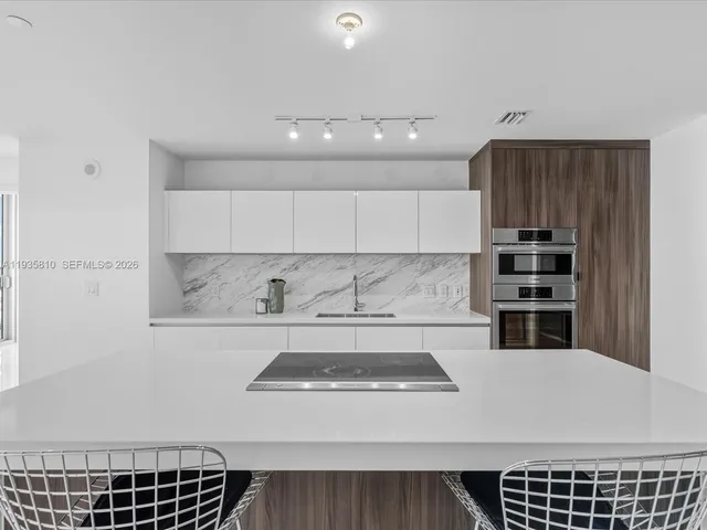 a kitchen with a stove a sink and a refrigerator