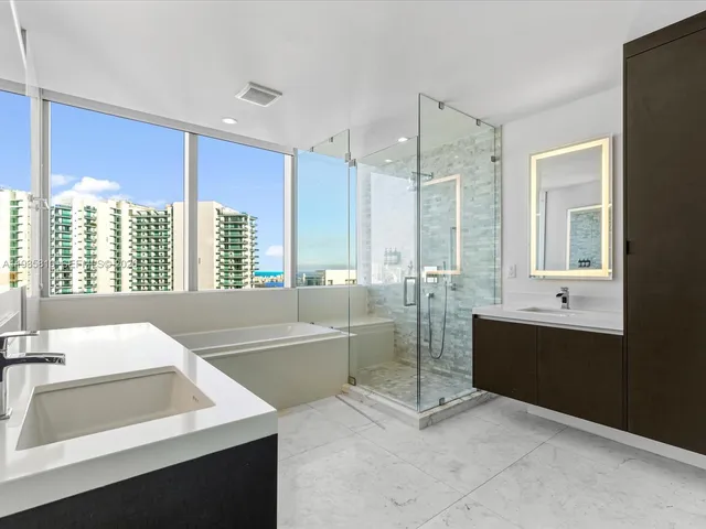 a spacious bathroom with a tub sink and shower