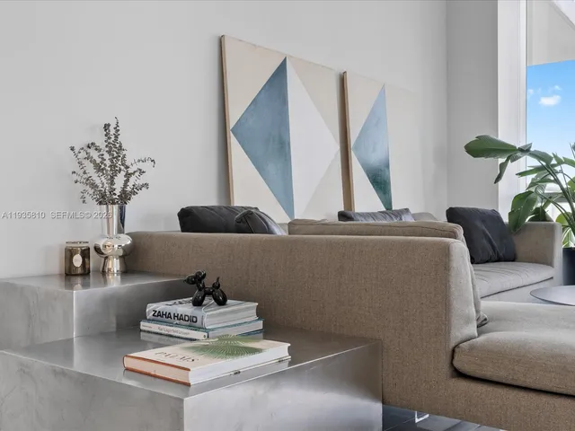 a living room with furniture and a potted plant