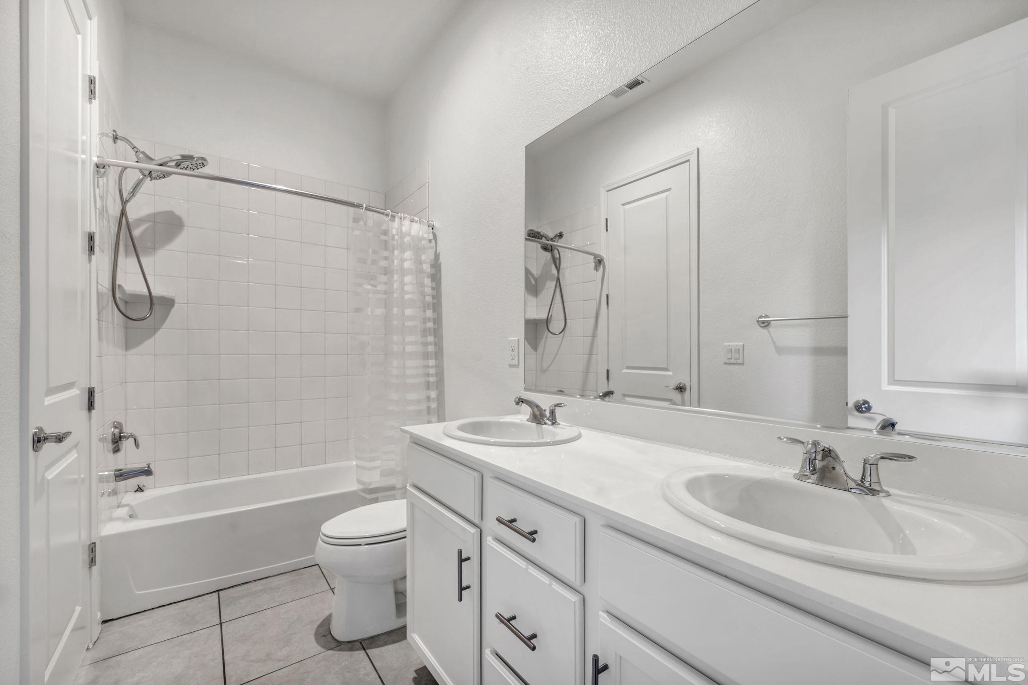 2013 Neviekay Lane Reno, NV 89521 - Photo 24 of 35 a bathroom with a granite countertop sink a toilet and shower