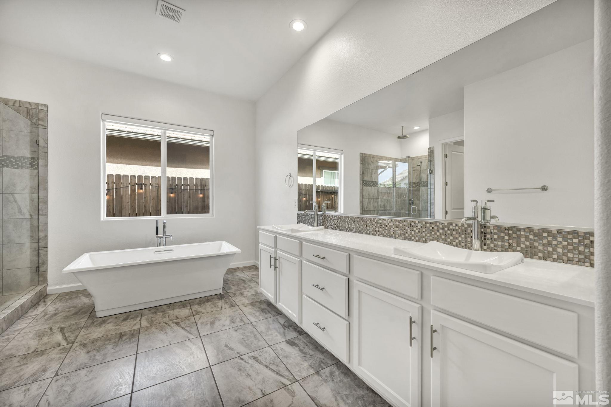2013 Neviekay Lane Reno, NV 89521 - Photo 26 of 35 a spacious bathroom with a granite countertop sink a mirror and a bathtub