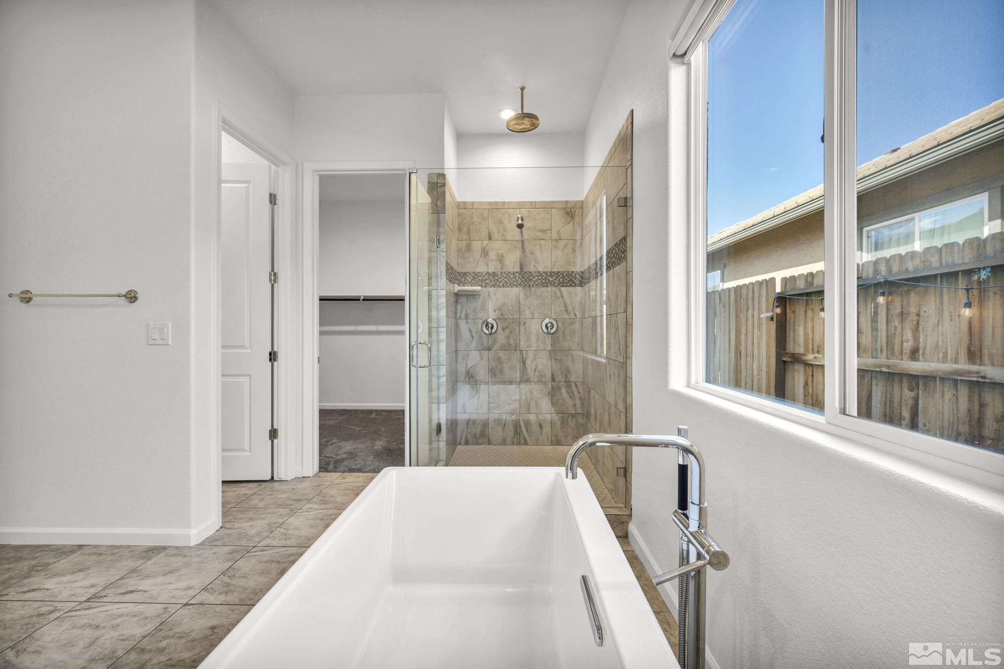 2013 Neviekay Lane Reno, NV 89521 - Photo 29 of 35 a bathroom with a bathtub and a shower