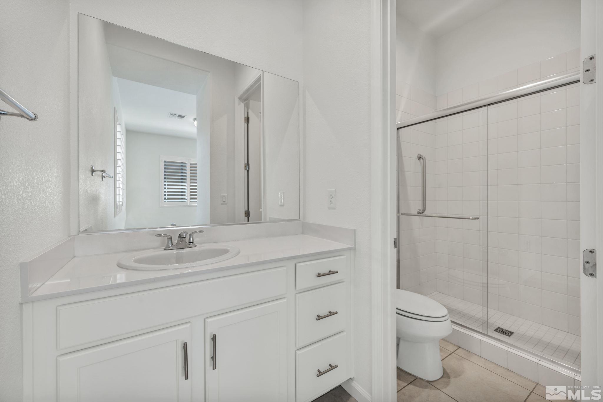 2013 Neviekay Lane Reno, NV 89521 - Photo 31 of 35 a bathroom with a sink a toilet and shower