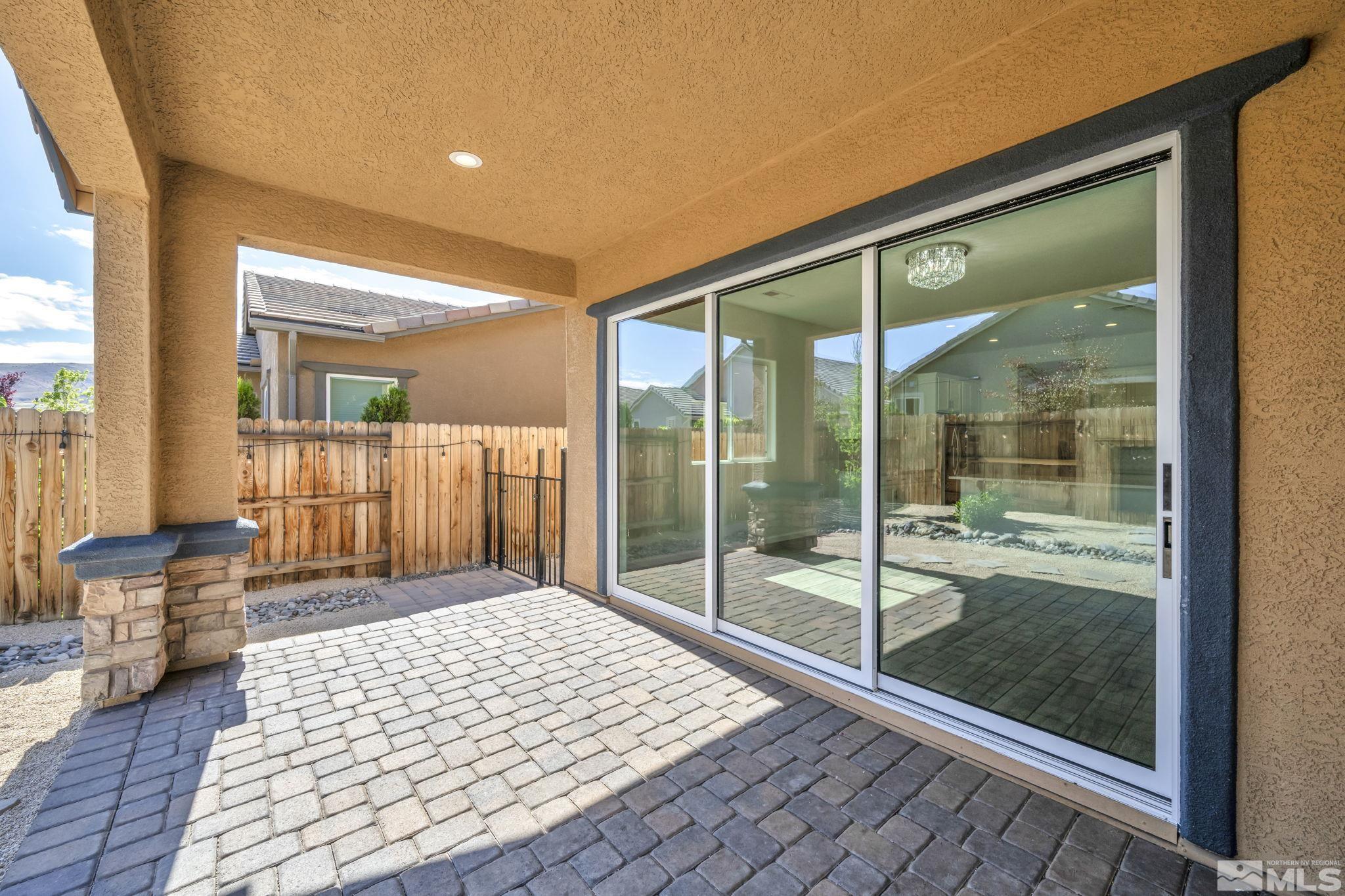 2013 Neviekay Lane Reno, NV 89521 - Photo 33 of 35 a bedroom with a large window and a balcony
