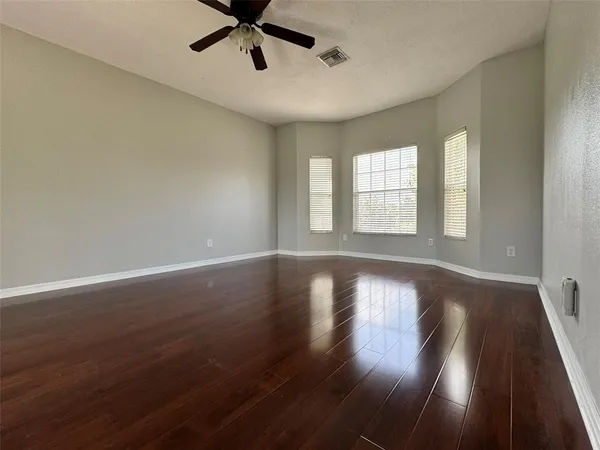 a view of wooden floor and windows in a room