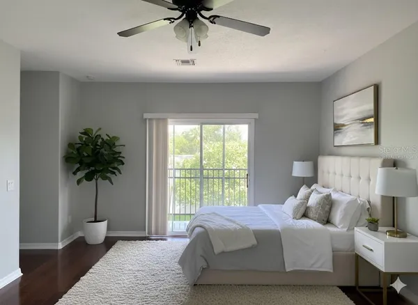 a bedroom with a bed and a potted plant