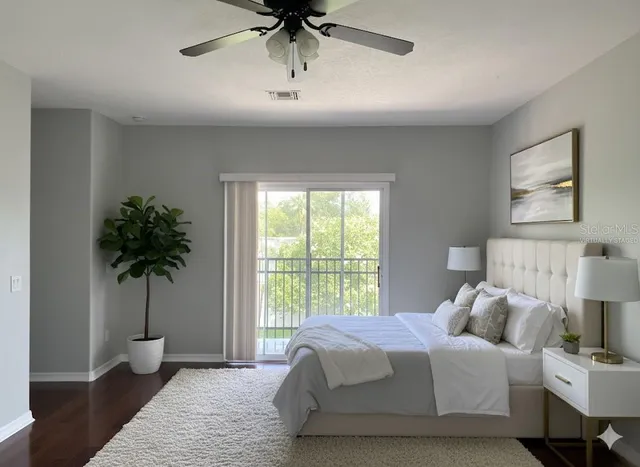a bedroom with a bed and a potted plant
