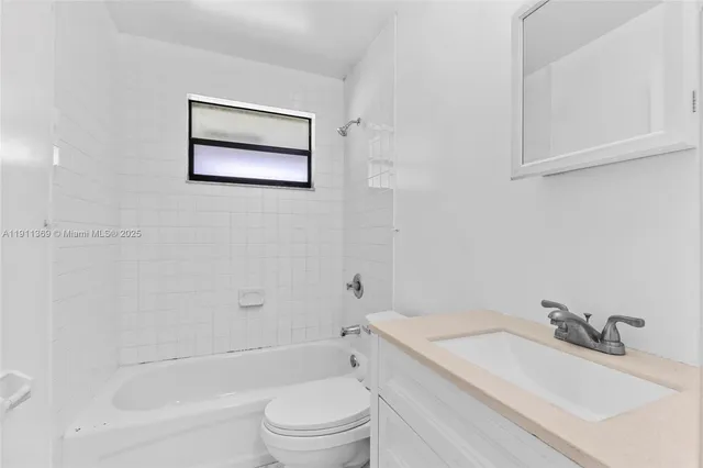 a bathroom with a sink toilet and vanity