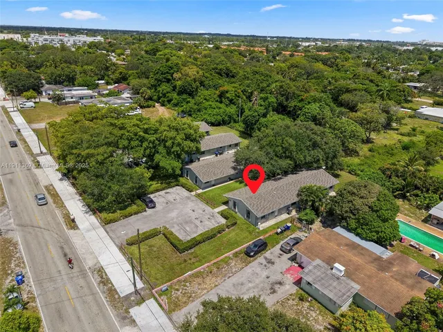 an aerial view of a house with pool