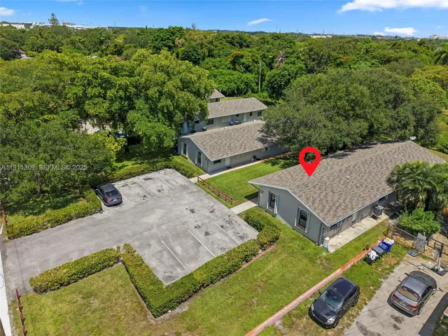 an aerial view of residential houses with city view