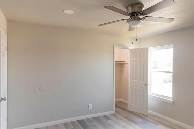 a bathroom with a granite countertop sink toilet and a mirror